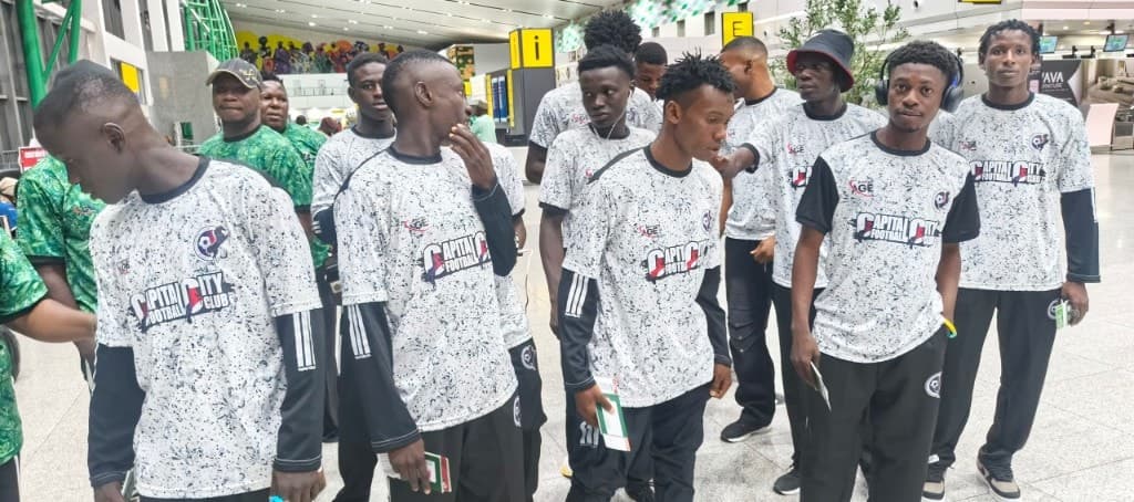 The squad in club colours at the terminal.