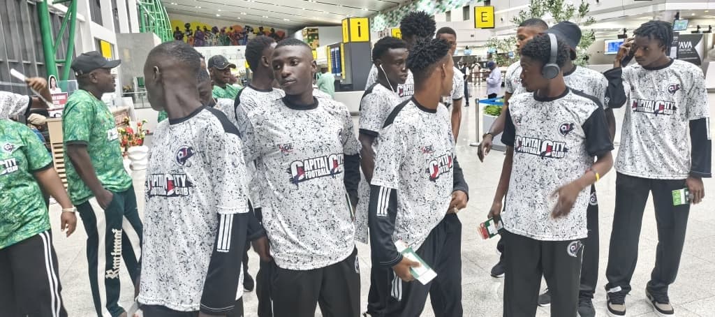Players in travelling kit as the group moves through the terminal.
